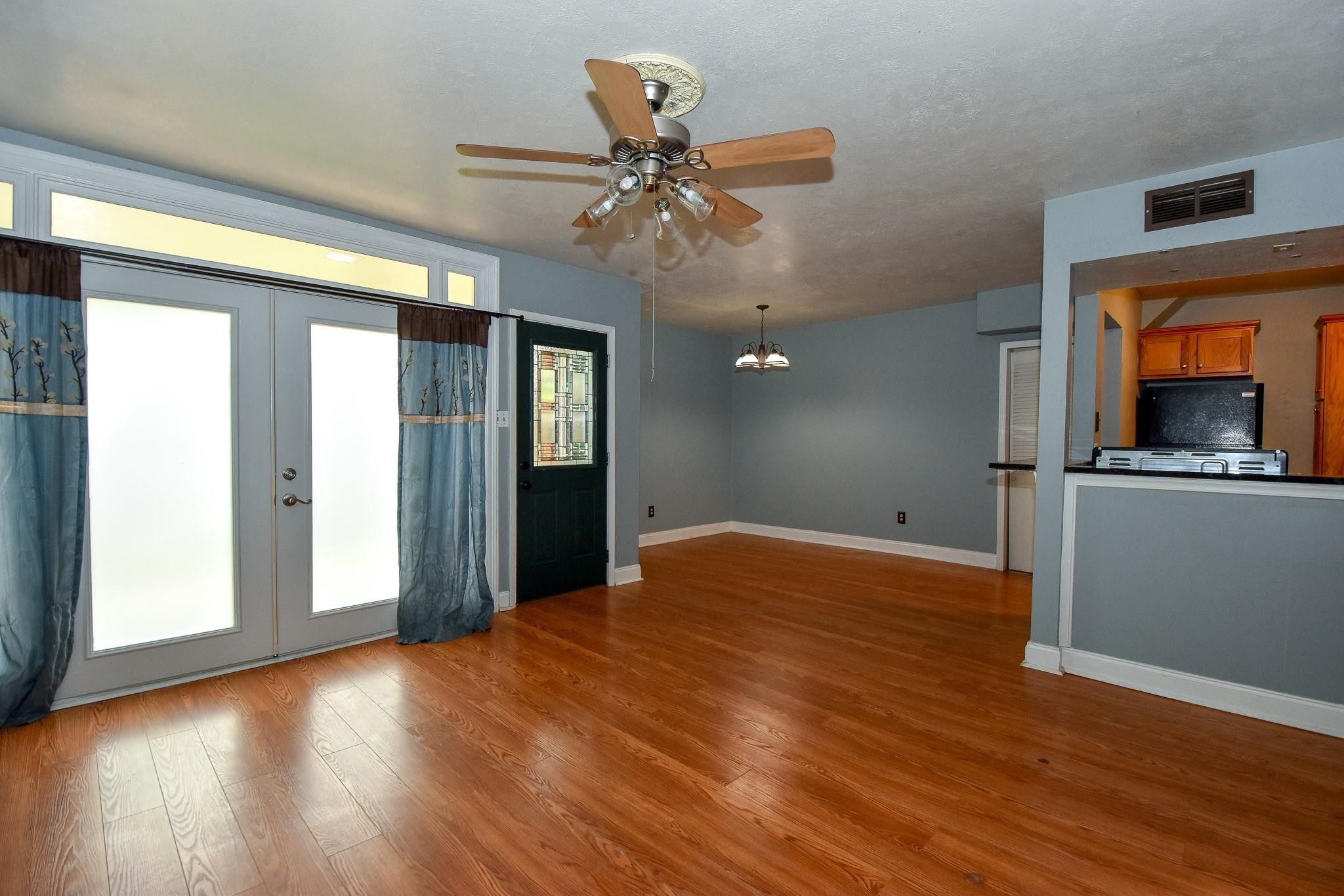 3400 Timmons Lane, Unit 78 Houston, TX 77027 - Photo 4 of 20 a workspace with wooden floor a ceiling fan and a window