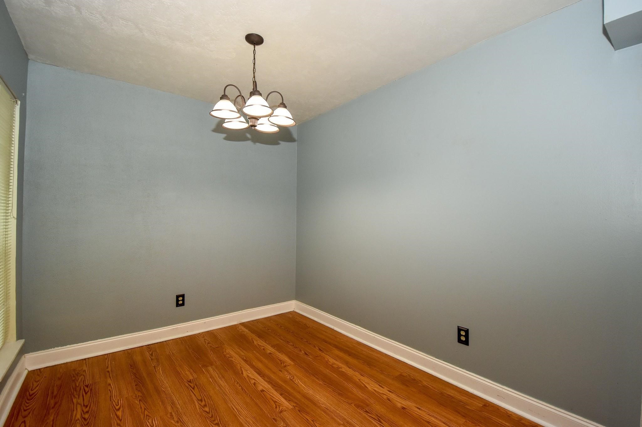 3400 Timmons Lane, Unit 78 Houston, TX 77027 - Photo 7 of 20 a view of a room with wooden floor chandelier fan and windows
