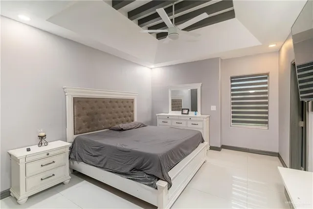 a bedroom with a large bed and a window