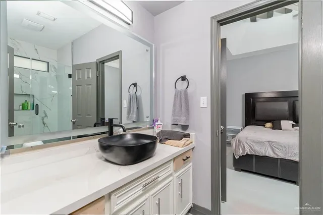 a en suite bathroom with a sink and a mirror