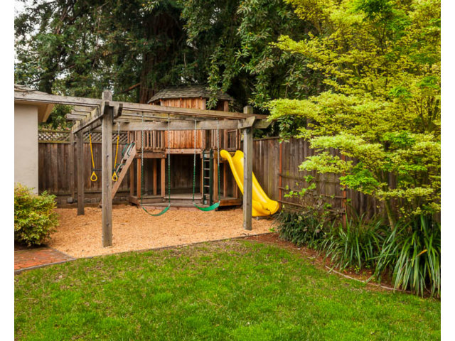 145 Cornell Road Menlo Park, CA 94025 - Photo 11 of 14 a view of a backyard with plants and brick wall