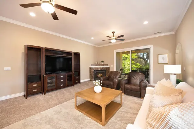 a kitchen with kitchen island granite countertop wooden cabinets a stove a sink and a window