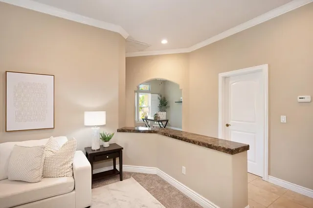 a kitchen with stainless steel appliances kitchen island granite countertop a refrigerator and a stove top oven