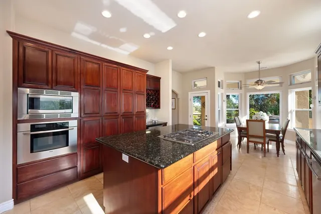 a spacious bathroom with a granite countertop sink a mirror and a shower