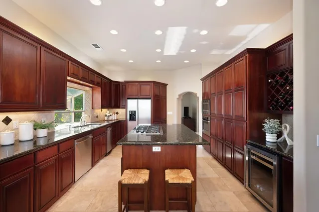 a bedroom with a large bed and a chandelier