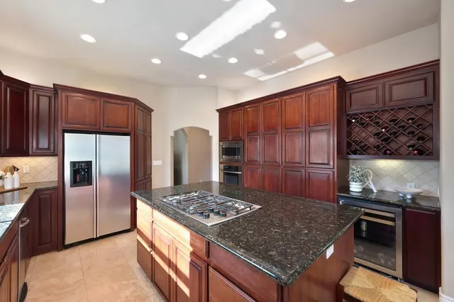 a bedroom with a large bed and a chandelier