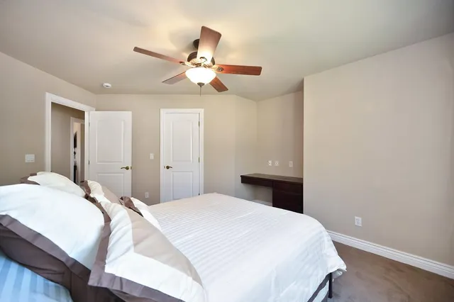a view of a patio with table and chairs and potted plants with wooden floor and fence