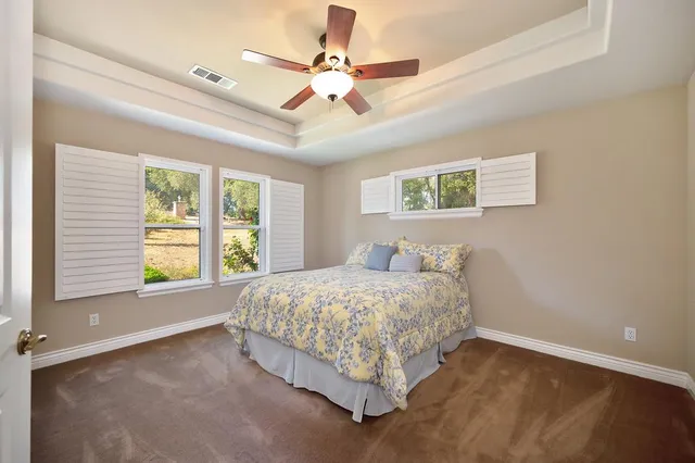 a view of a patio with chairs and plants