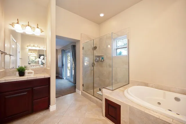 a view of a chair and table in backyard of the house
