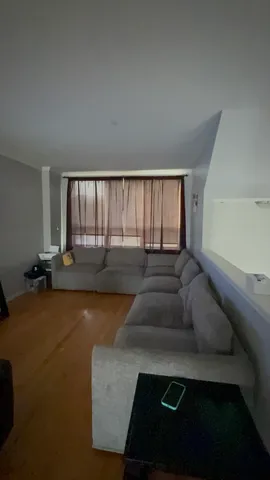 a living room with furniture and a floor to ceiling window