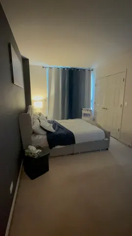 a bedroom with a bed couch and a window