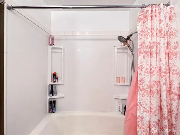 a bathroom with a bathtub and a shower