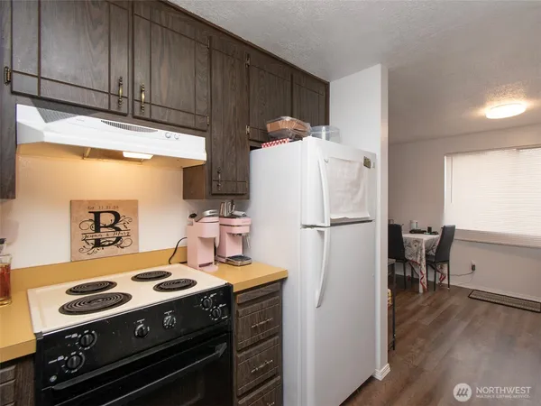 a kitchen with a stove and a refrigerator