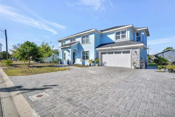 a view of a house with a swimming pool and a yard