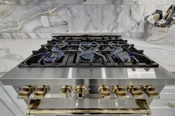 a kitchen with granite countertop a sink a center island and cabinets
