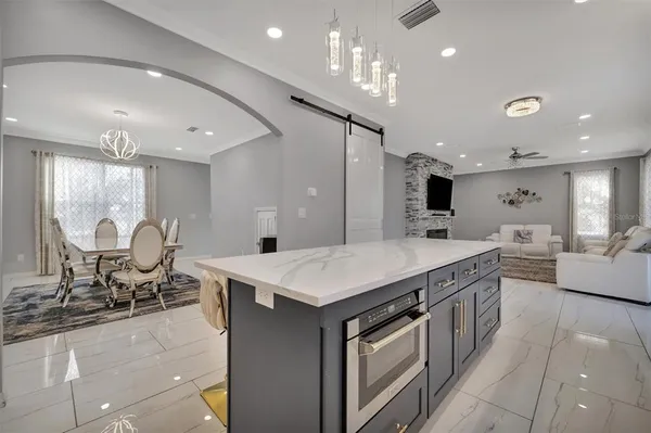 a living room with furniture and kitchen view