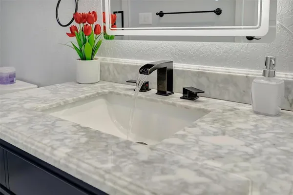 a hallway with stairs and a couch