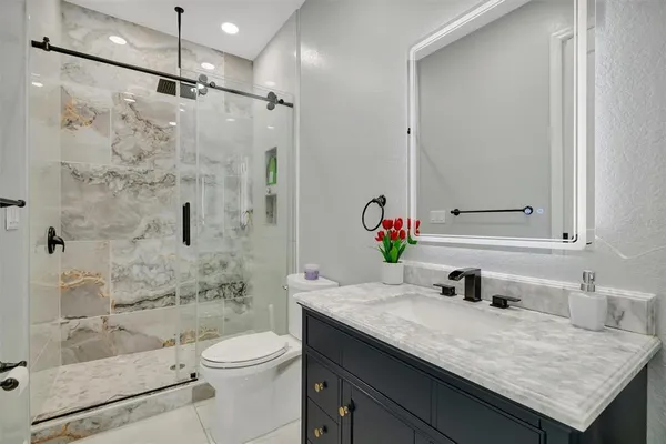 a bedroom with a large bed rug and wall painting