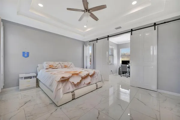 a bedroom with a bed and a chandelier