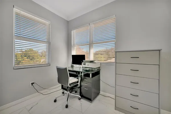 a en suite bathroom with a granite countertop sink and a mirror