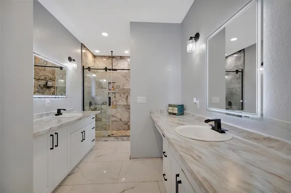 a bedroom with a bed and flat screen tv