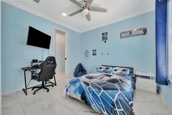 a view of a patio with couches and table under an umbrella next to a road