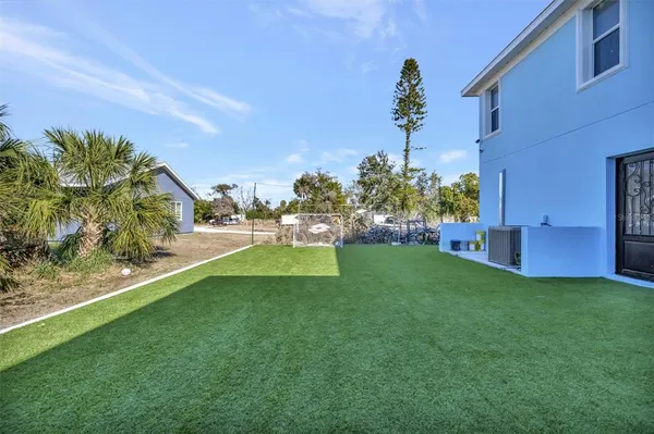 a view of patio with table and chairs and potted plants