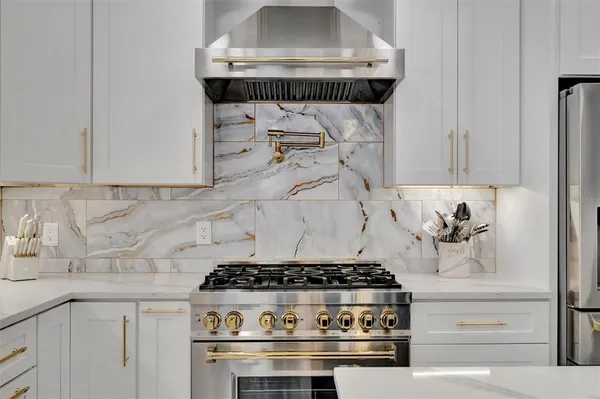 a large kitchen with a table and chairs