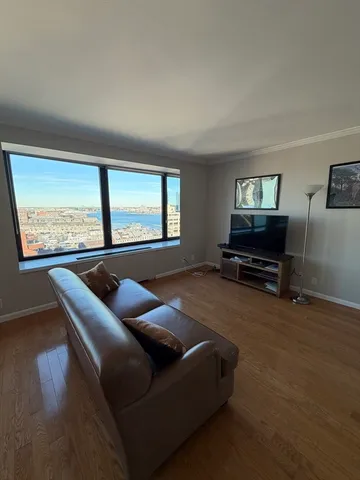 a view of a livingroom with furniture hardwood floor and workspace