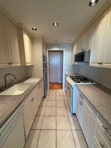 a bathroom with a sink vanity and toilet
