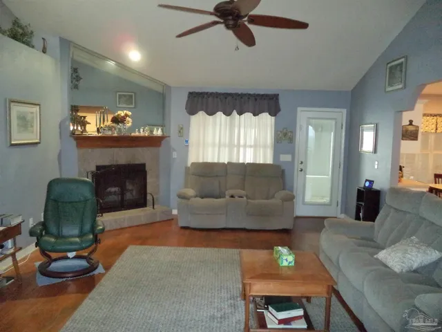 a living room with furniture and a fireplace
