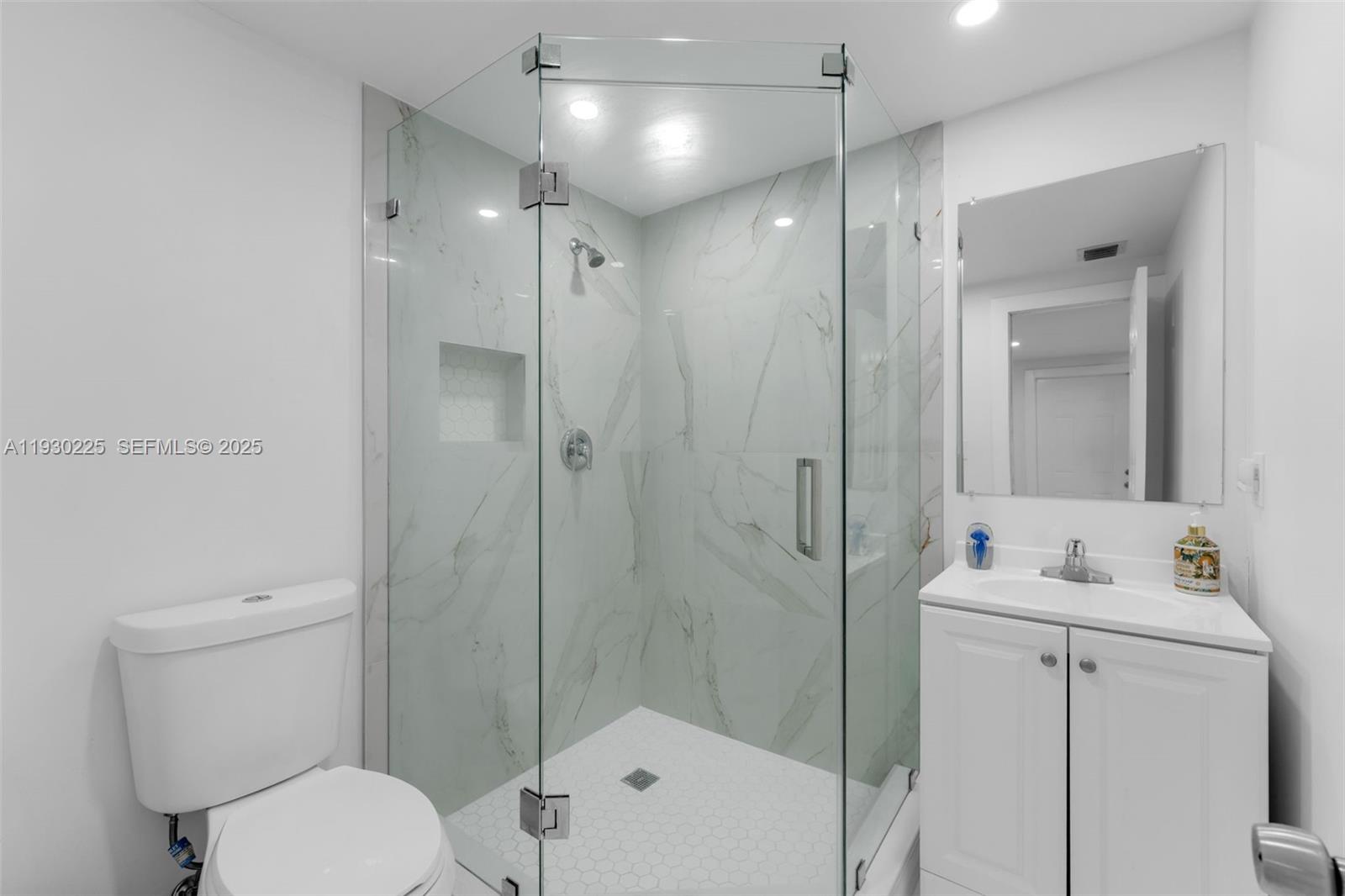 11966 Southwest 271st Street Homestead, FL 33032 - Photo 13 of 41 a bathroom with a toilet sink vanity and shower