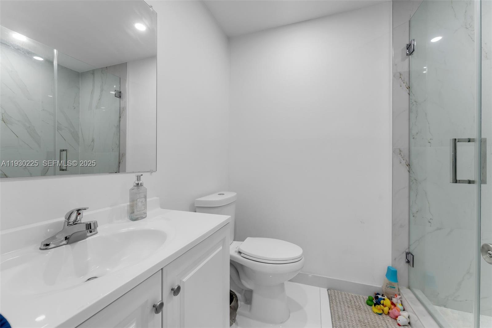 11966 Southwest 271st Street Homestead, FL 33032 - Photo 16 of 41 a bathroom with a sink a toilet and a mirror