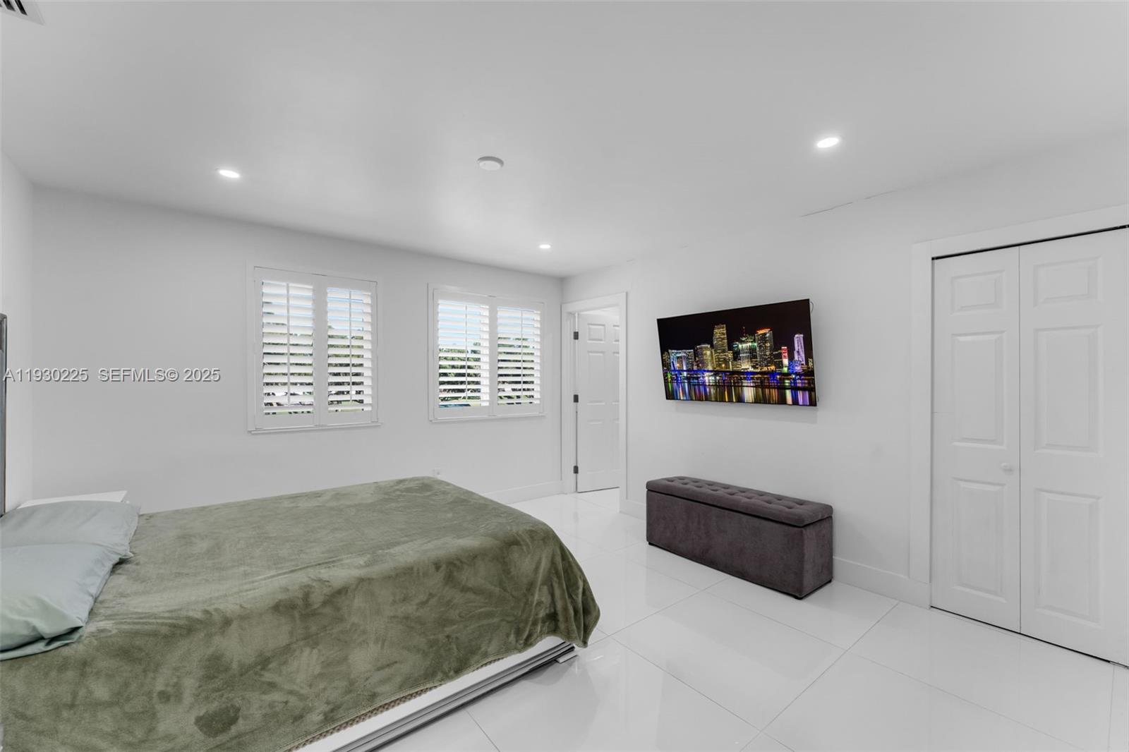 11966 Southwest 271st Street Homestead, FL 33032 - Photo 18 of 41 a bedroom with a bed and a couch