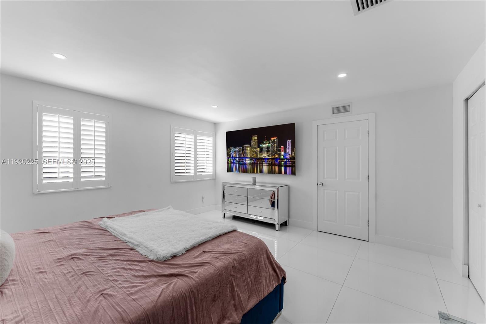 11966 Southwest 271st Street Homestead, FL 33032 - Photo 23 of 41 a bedroom with a bed and a flat screen tv