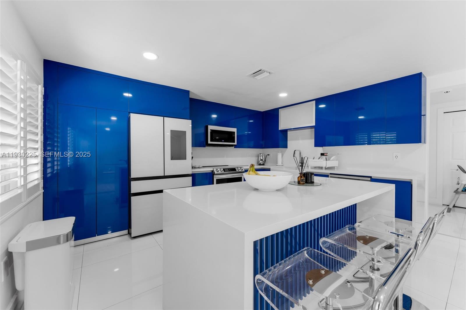 11966 Southwest 271st Street Homestead, FL 33032 - Photo 5 of 41 a kitchen with stainless steel appliances a sink a stove a refrigerator cabinets and a chairs