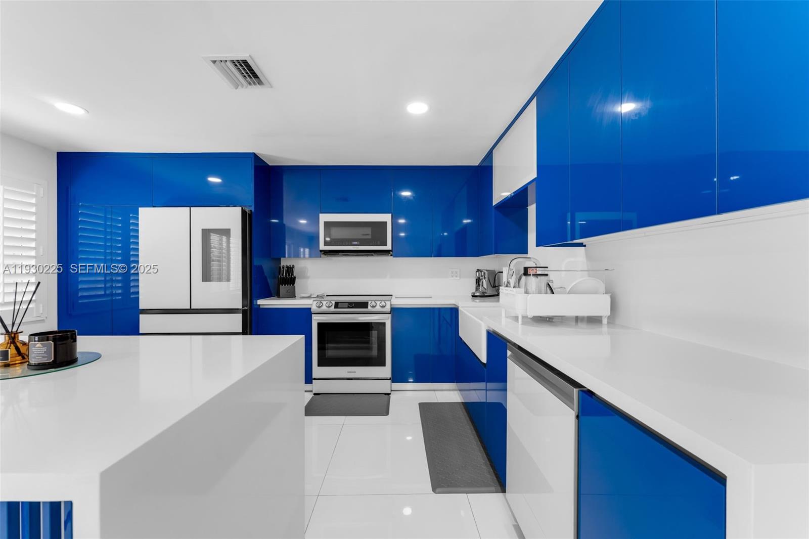 11966 Southwest 271st Street Homestead, FL 33032 - Photo 6 of 41 a kitchen with stainless steel appliances kitchen island granite countertop a sink dishwasher stove and refrigerator