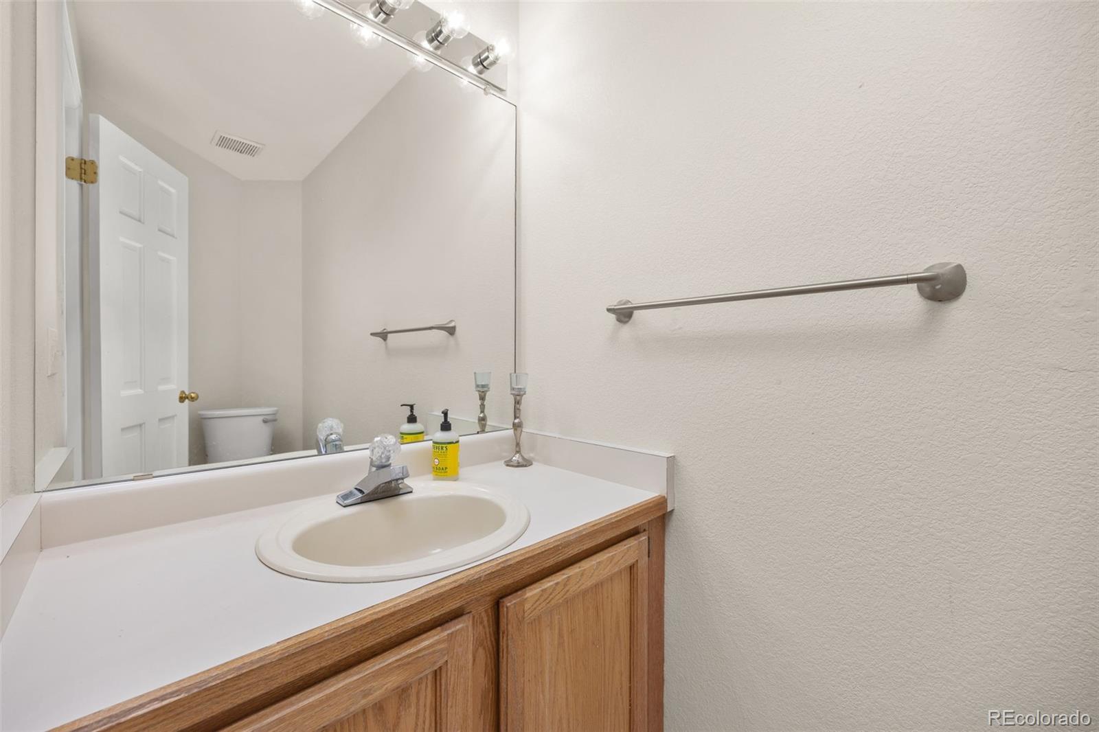 6868 Johnson Street Arvada, CO 80004 - Photo 12 of 39 a bathroom with a sink and a mirror