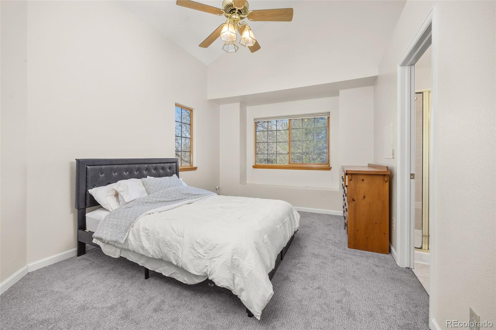 6868 Johnson Street Arvada, CO 80004 - Photo 14 of 39 a bedroom with a bed and a chandelier