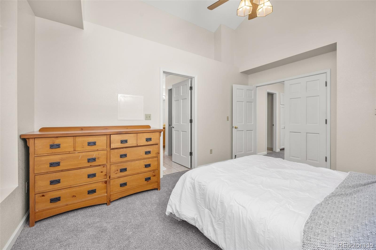 6868 Johnson Street Arvada, CO 80004 - Photo 15 of 39 a bedroom with a bed and a dresser