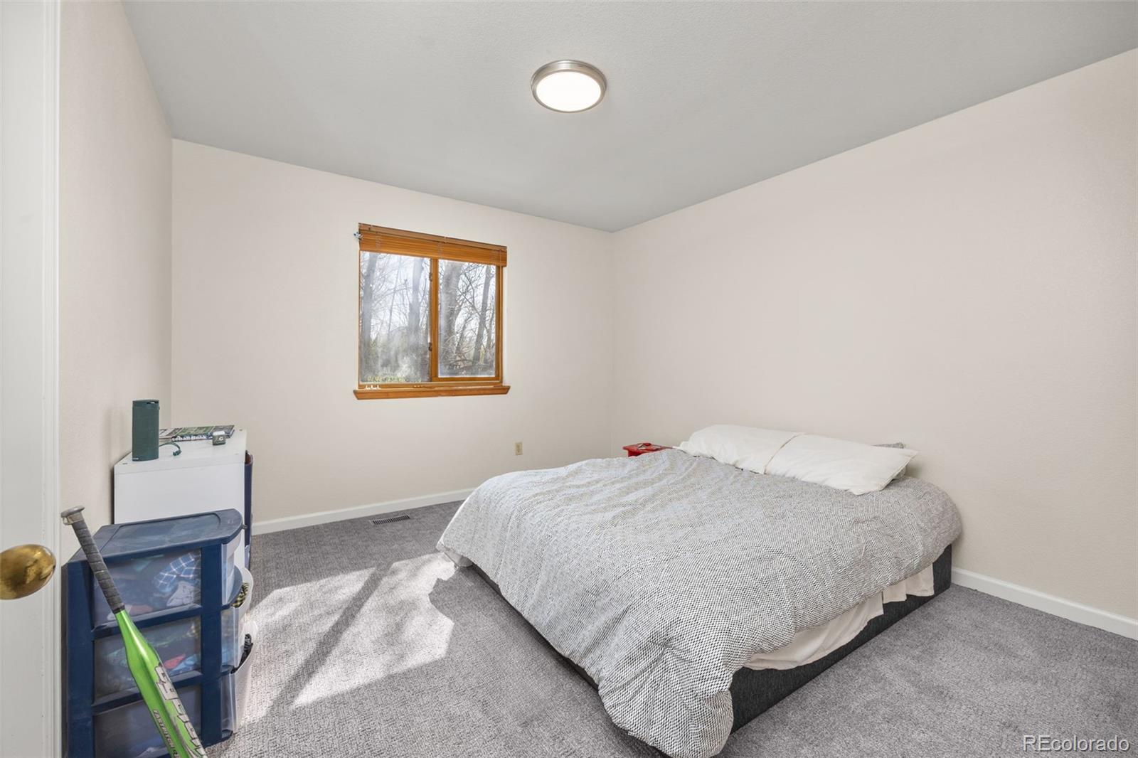 6868 Johnson Street Arvada, CO 80004 - Photo 18 of 39 a bedroom with a bed and a window