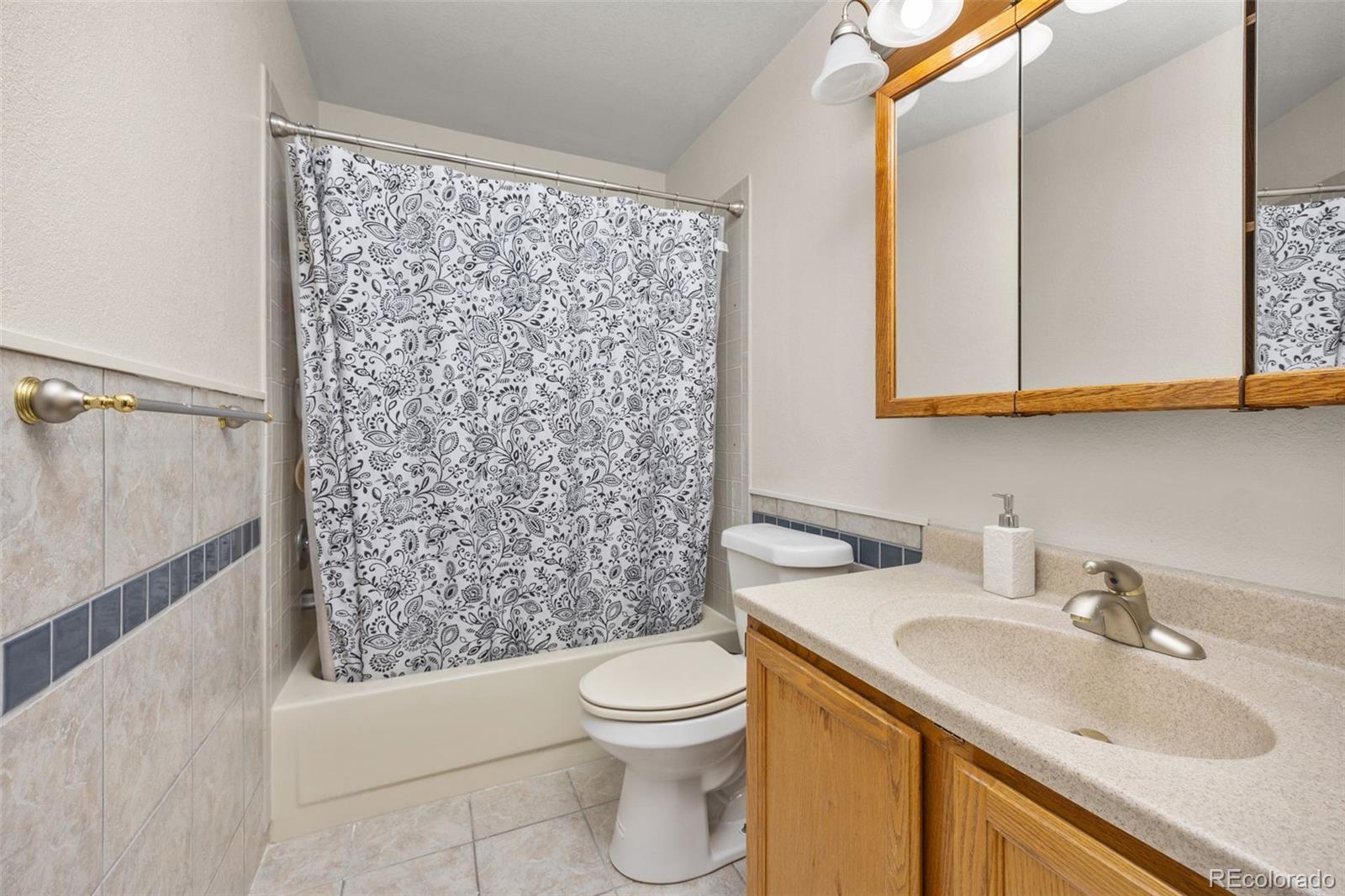 6868 Johnson Street Arvada, CO 80004 - Photo 19 of 39 a bathroom with a sink toilet and shower