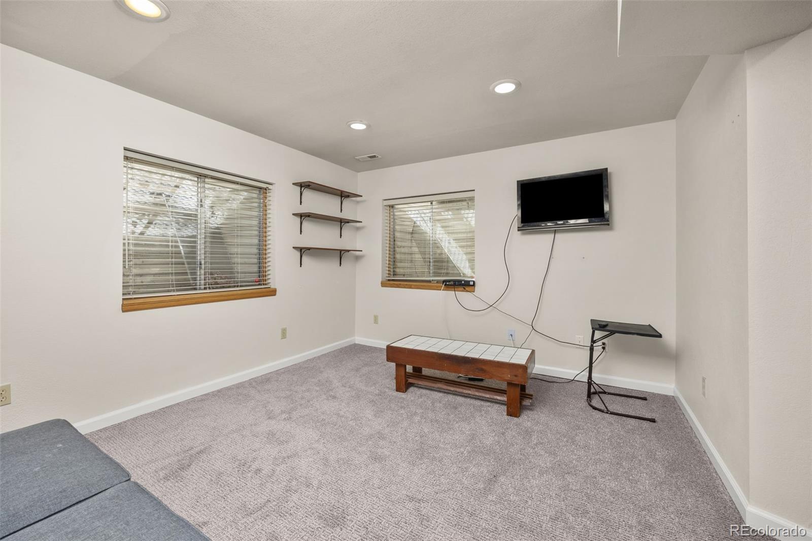 6868 Johnson Street Arvada, CO 80004 - Photo 20 of 39 a living room with furniture and a flat screen tv