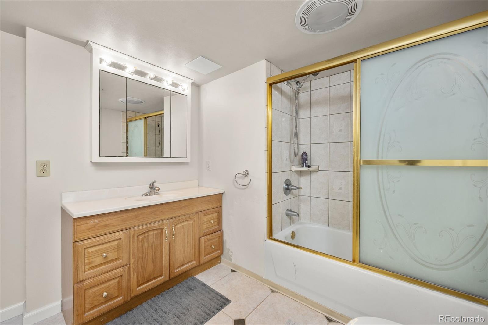 6868 Johnson Street Arvada, CO 80004 - Photo 25 of 39 a bathroom with a double vanity sink a mirror and a shower