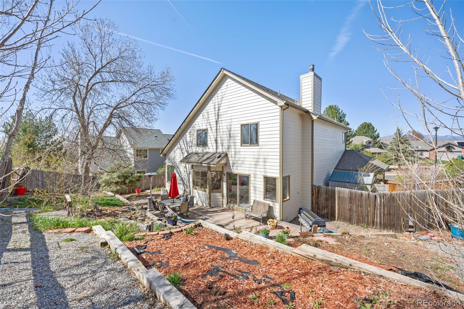 6868 Johnson Street Arvada, CO 80004 - Photo 30 of 39 a view of a house with a yard