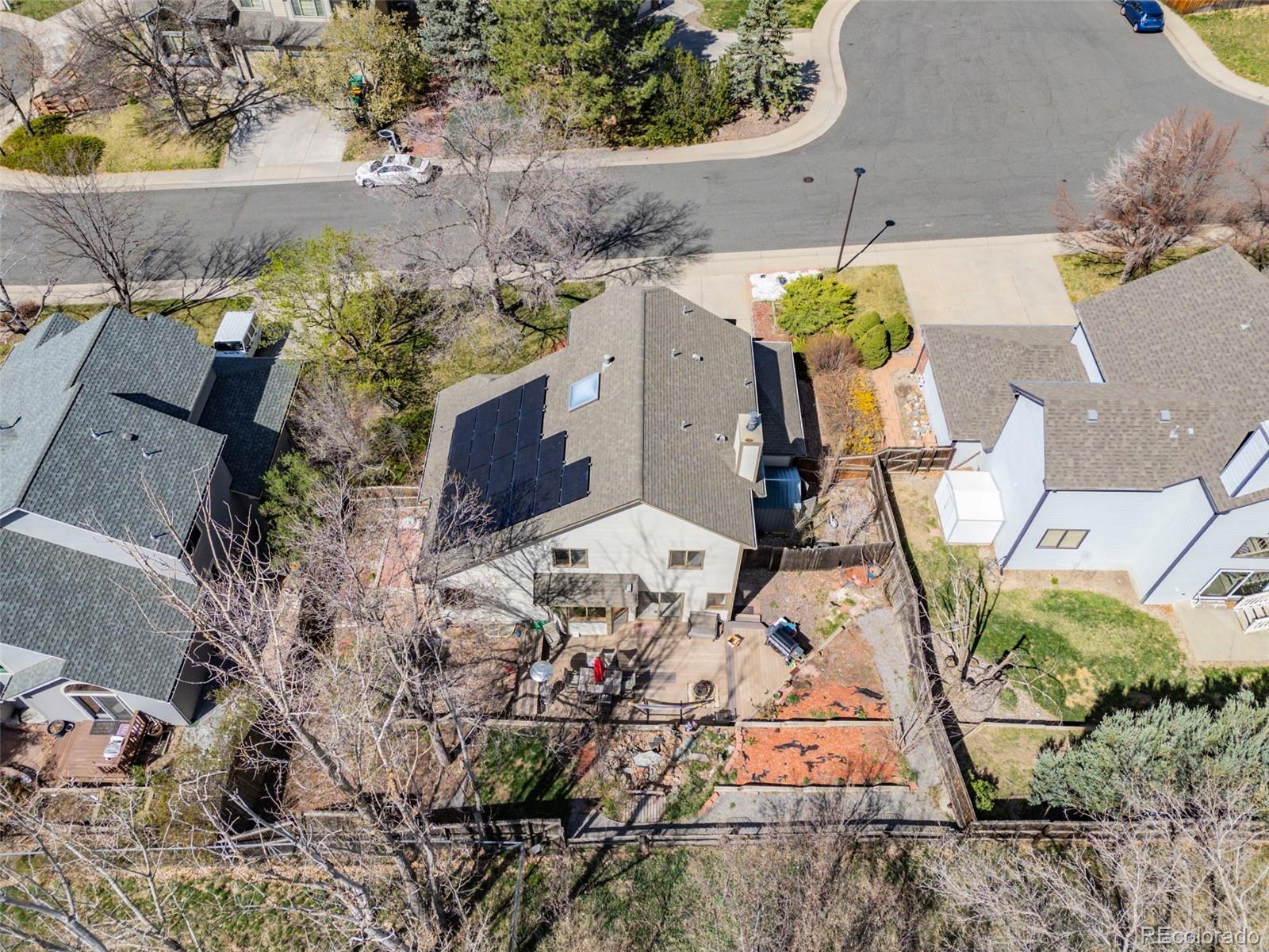 6868 Johnson Street Arvada, CO 80004 - Photo 31 of 39 an aerial view of a house with a yard and large trees