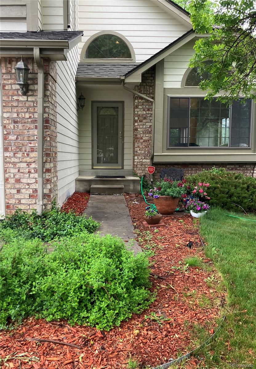 6868 Johnson Street Arvada, CO 80004 - Photo 37 of 39 a front view of a house with garden