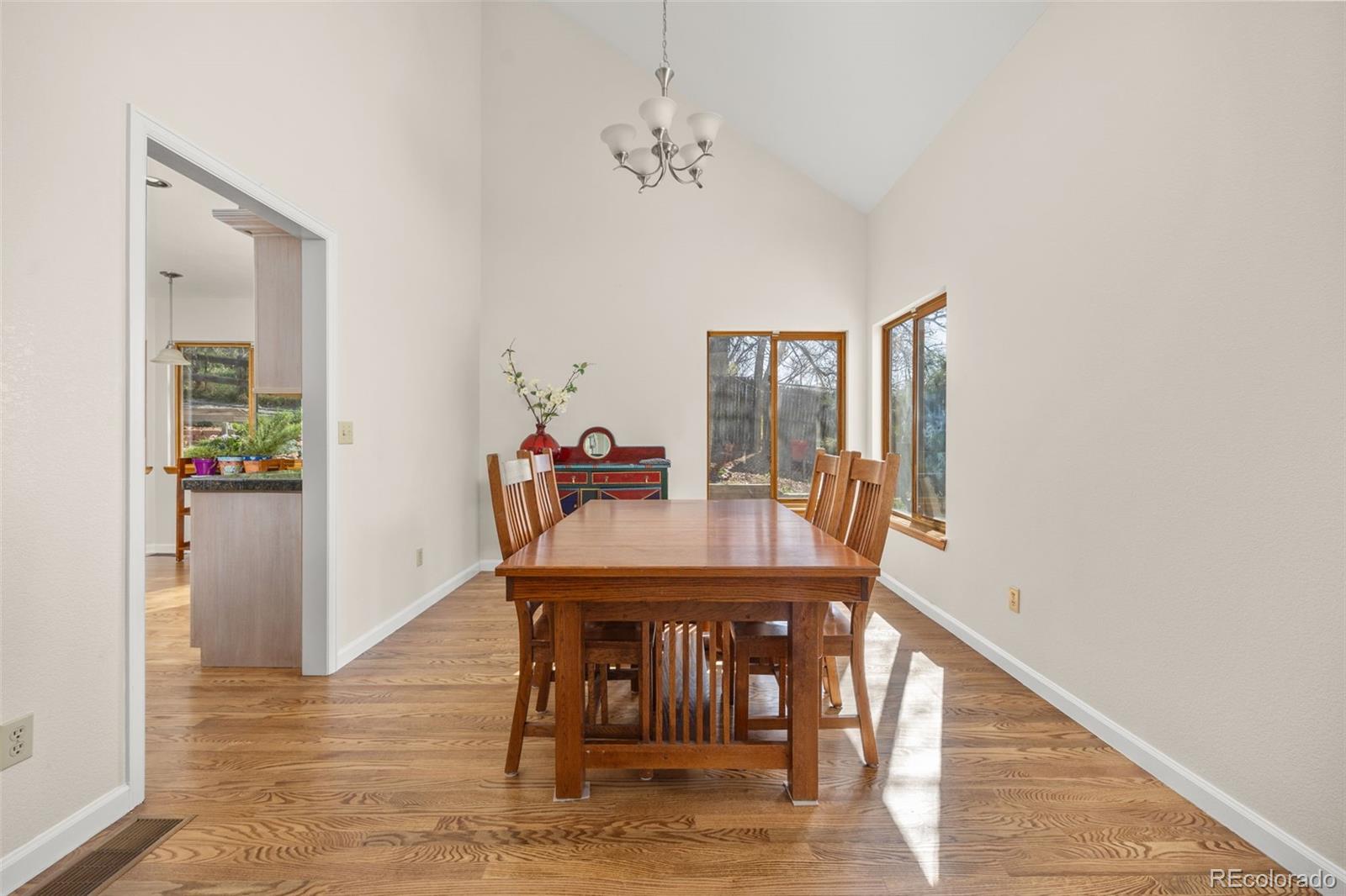6868 Johnson Street Arvada, CO 80004 - Photo 6 of 39 a view of a dining room with furniture and wooden floor