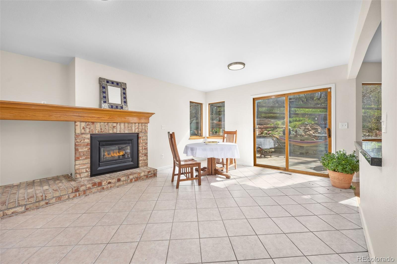 6868 Johnson Street Arvada, CO 80004 - Photo 7 of 39 a living room with furniture and a fireplace
