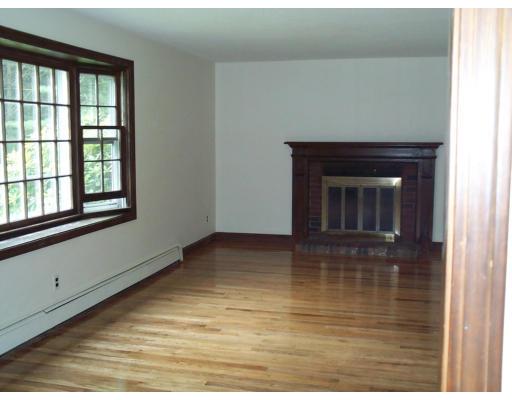 29 Intervale Road Sudbury, MA 01776 - Photo 4 of 6 a view of empty room with wooden floor and fireplace